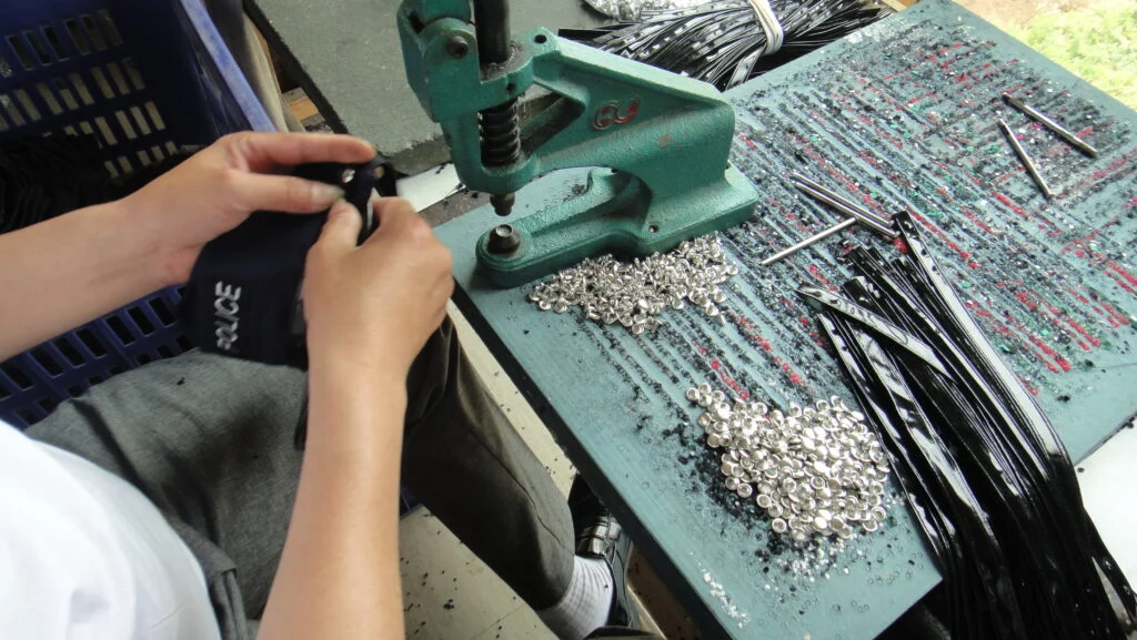 Sunspice Lingerie Setting rivets on PVC straps with a hand press