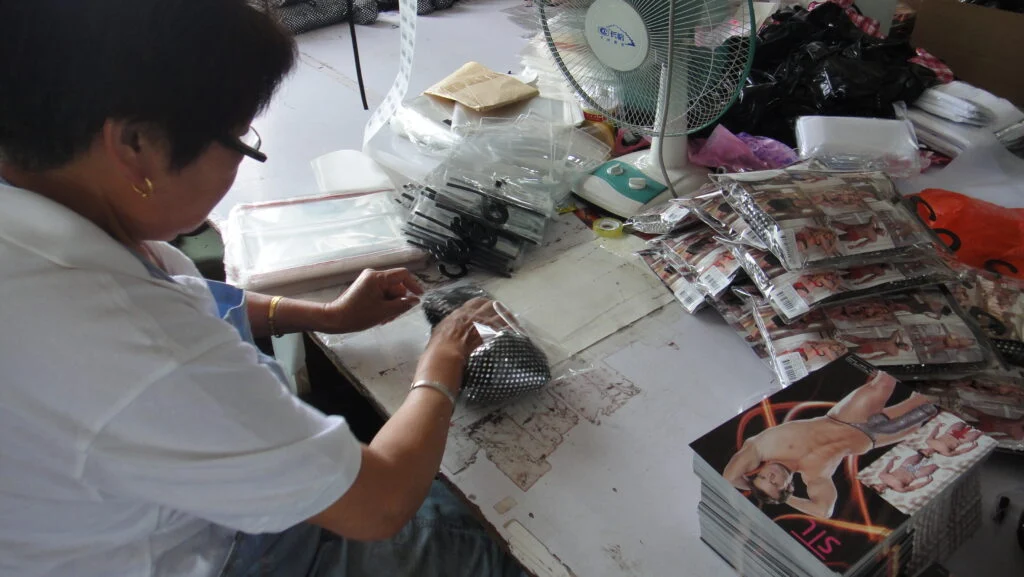 Sunspice Lingerie A worker bagging finished pieces